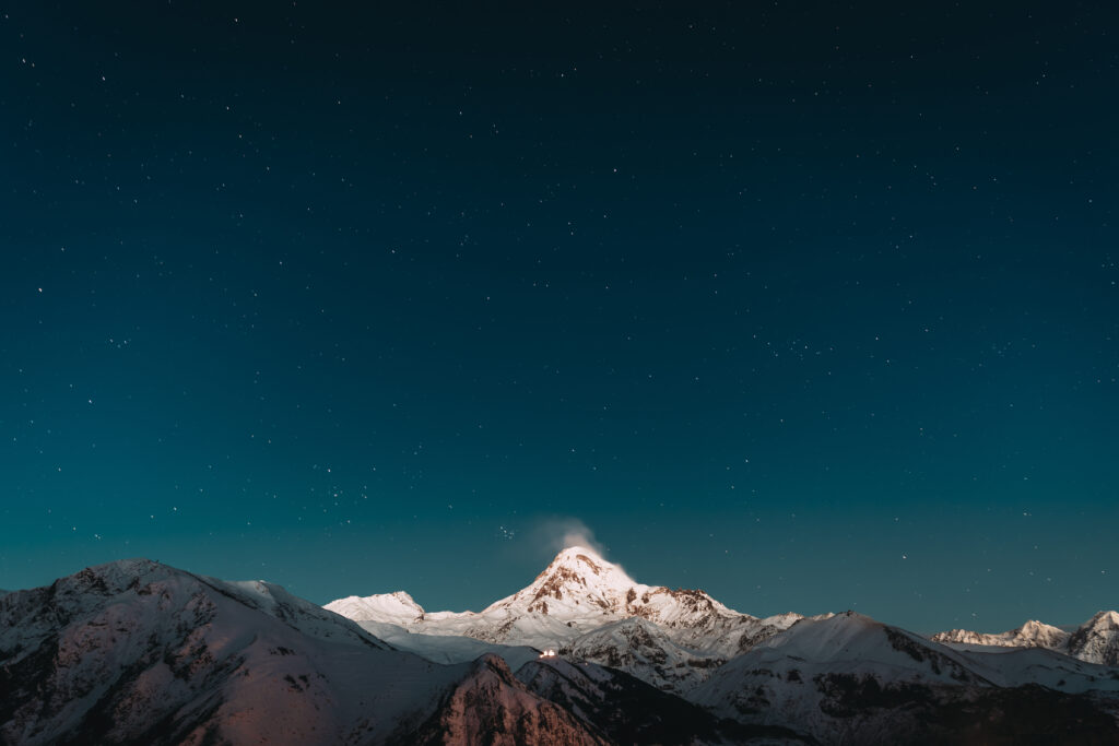 Georgia. Winter Night Starry Sky With Glowing Stars Over Peak Of